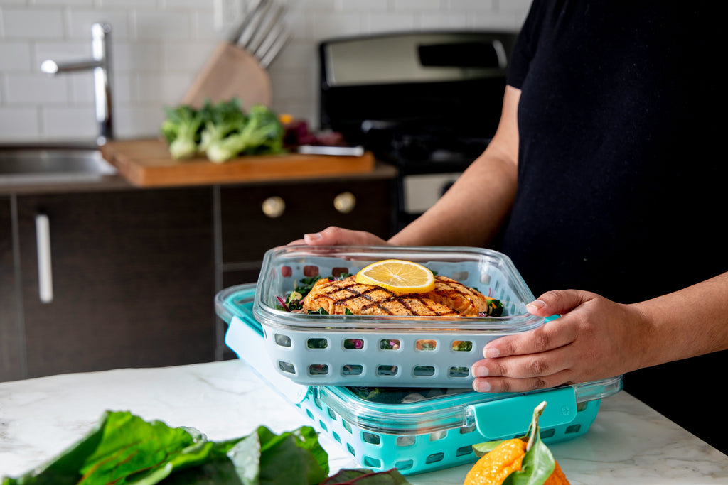 a person holding a meal prep container