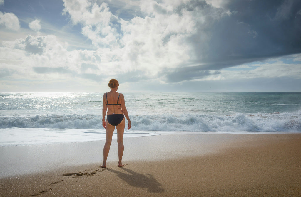 woman standing on the beach in bikinis