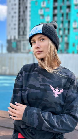 Czarina Masha is wearing a black camo long sleeve shirt with a pink embroidered eagle and an embroidered beanie hat from Czar Clothing in Minsk, Belarus.