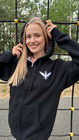 Czarina Masha is wearing a luxurious black hoodie with a white embroidered eagle and an eagle patterned hoodie liner for Czar Clothing in Minsk, Belarus.