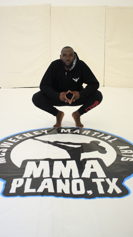 Jakori Savage, the Absolute Savage, wearing a black embroidered hoodie with a hoodie liner for Czar Clothing at Mcsweeney Martial Arts in Plano, Texas.