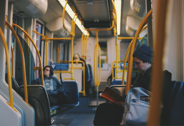 4 sustainable lifestyle goals for the new year - man taking public transportation