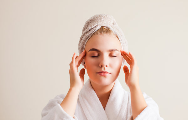 Woman giving herself a facial massage