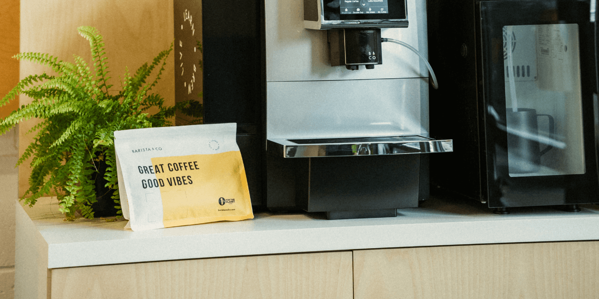 sealed bag of whole bean coffee with a bean-to-cup machine for offices