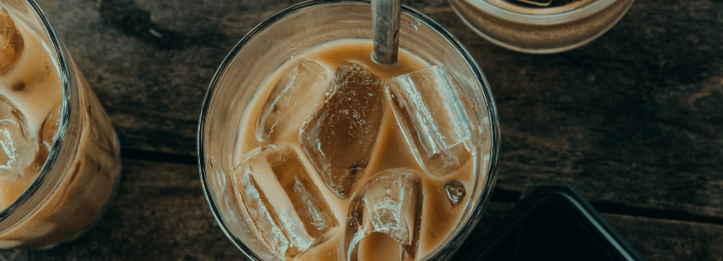 iced latte with milk against a dark background