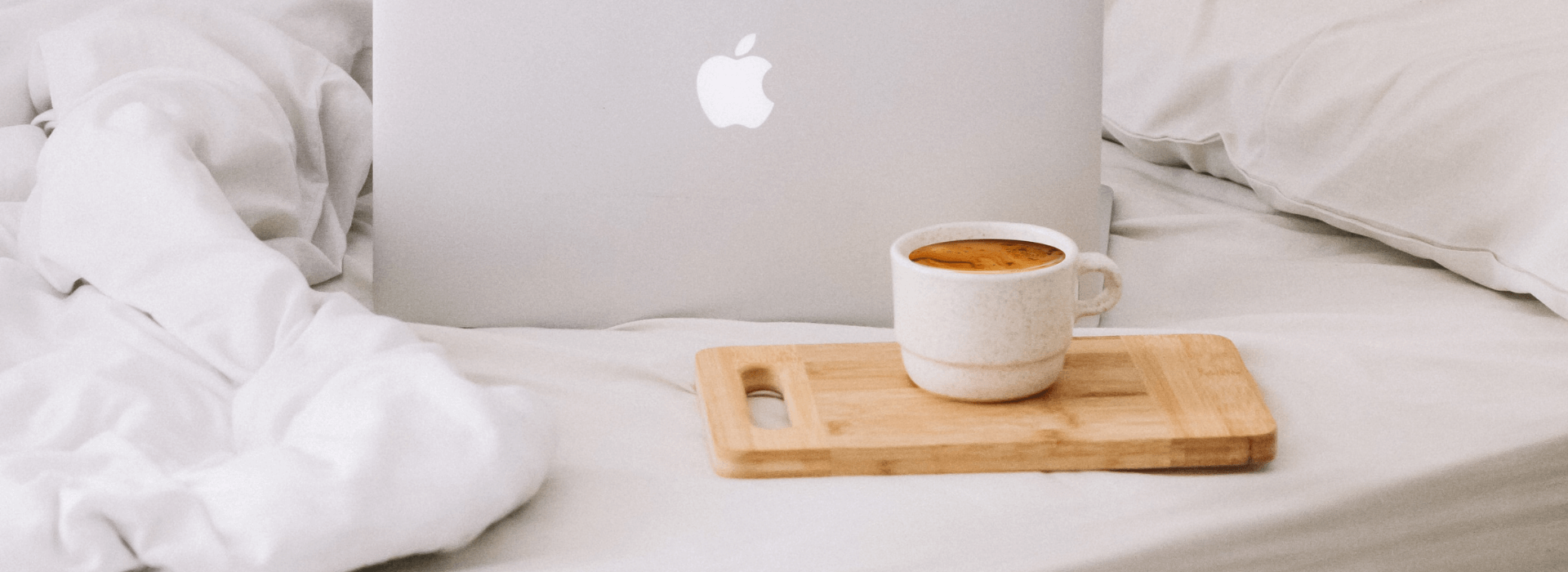 fresh coffee in bed with apple macbook