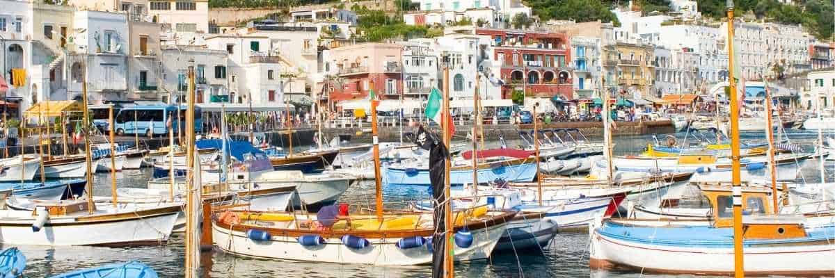 Porto di Marina Grande a Capri, con barche ormeggiate in primo piano e scorcio del borgo marinaro.