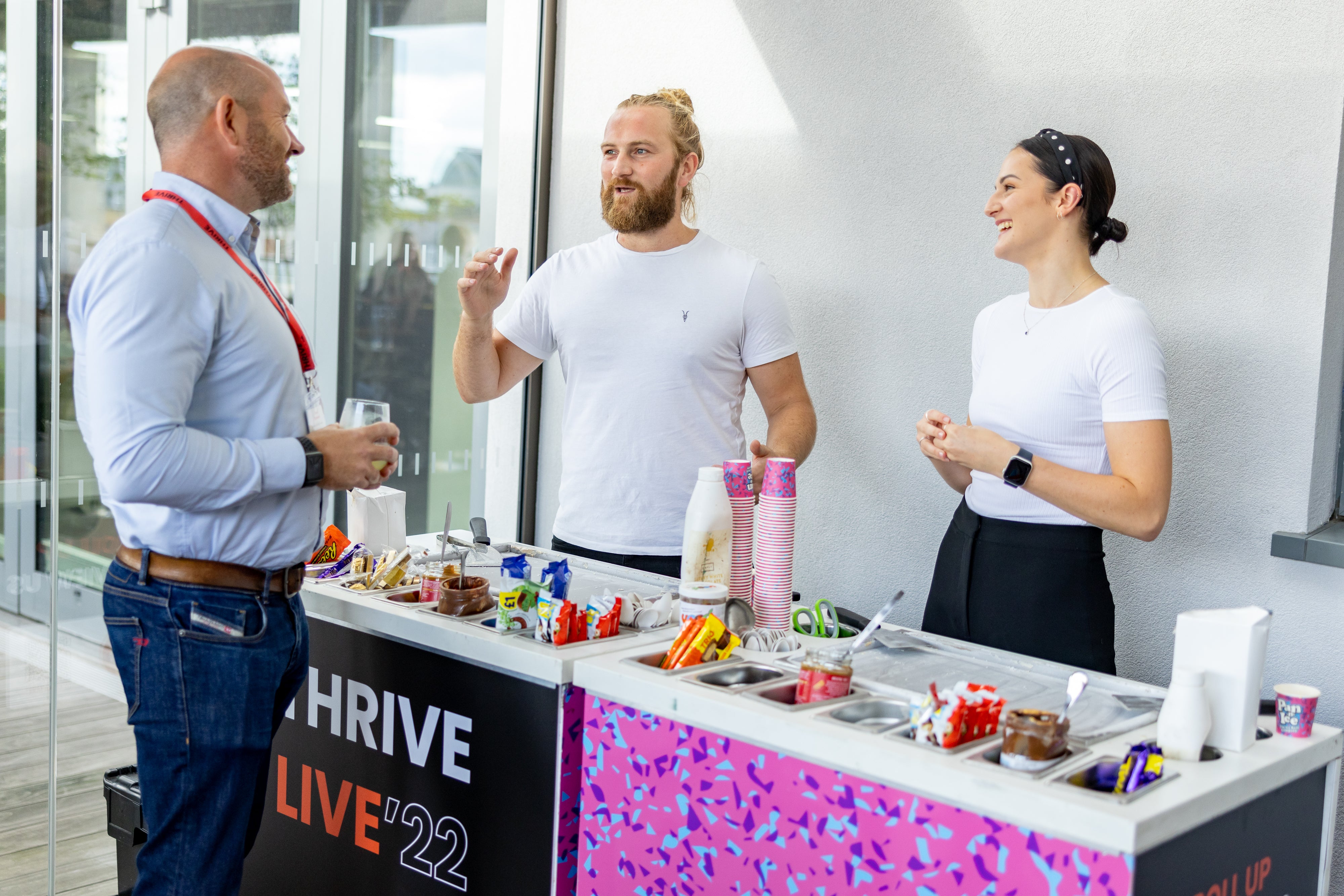 Man and woman serving ice cream to customer at a corporate event 