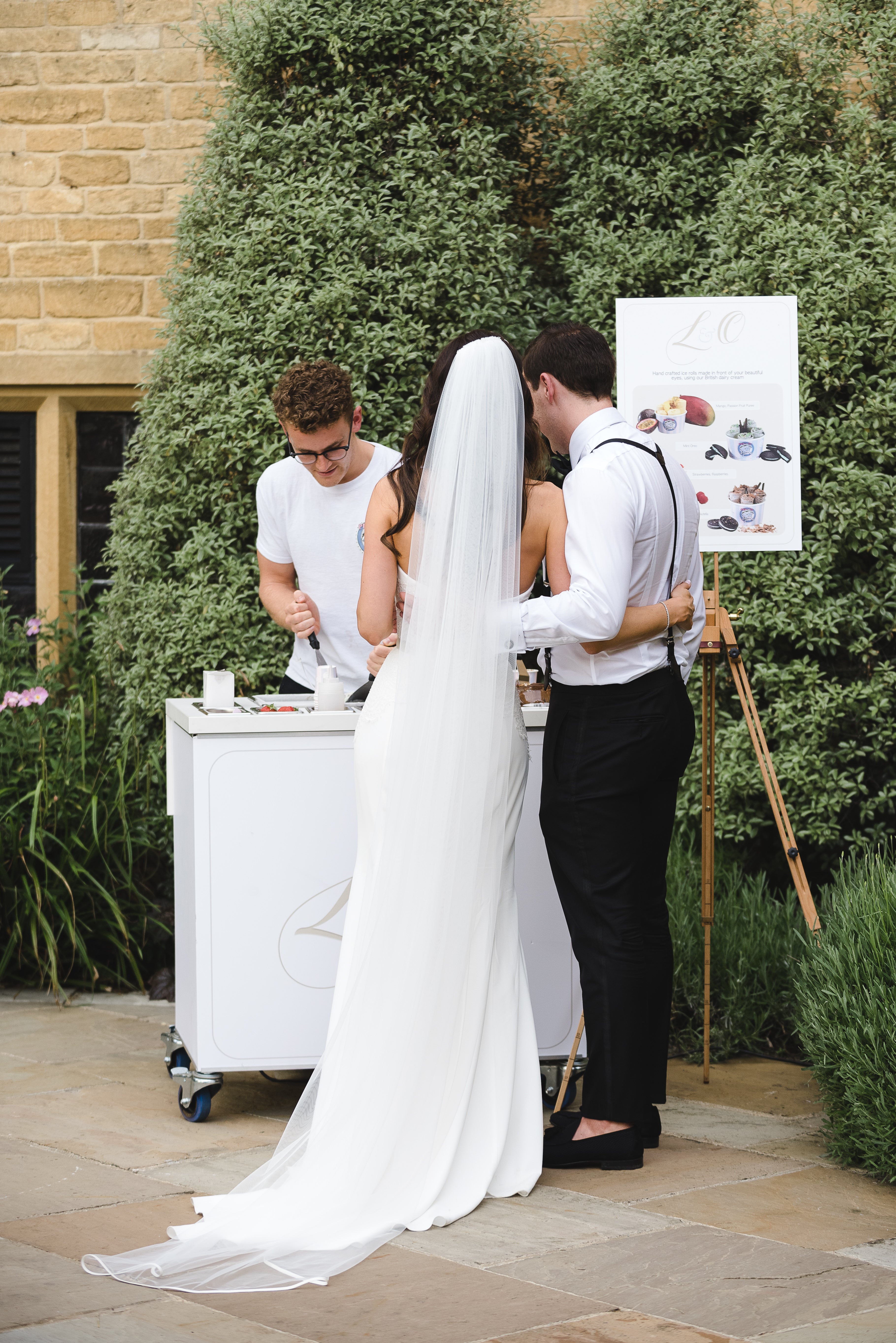 Bride and groom watching bespoke ice cream rolls made in front of them with customisable menus, cups, flavours and more 