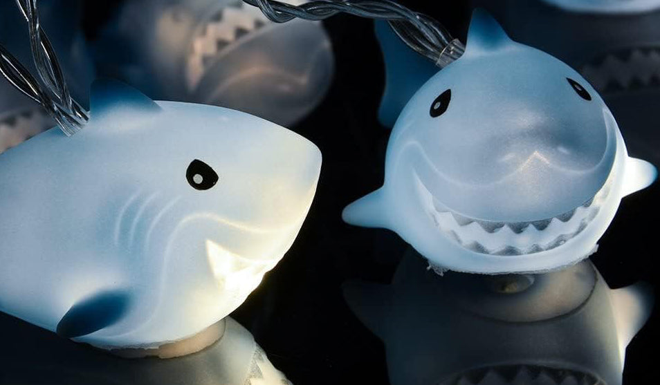 Slice through the darkness like this apex predator through the water with these iScream Shark Frenzy String Lights.