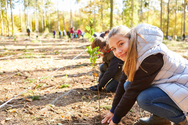 Summer camp kids planting trees