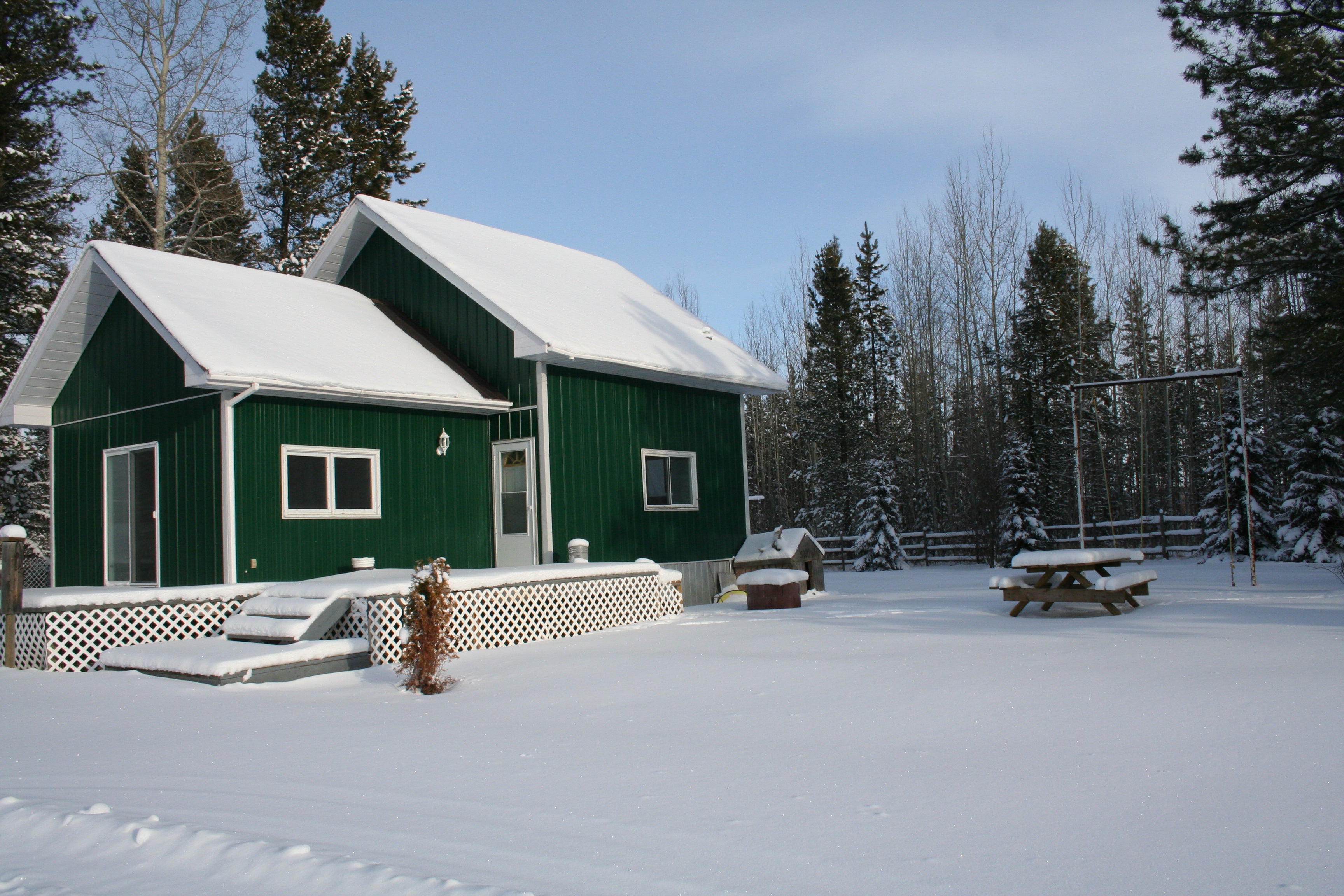 Last West Outfitting hunting lodge during winter time under the snow