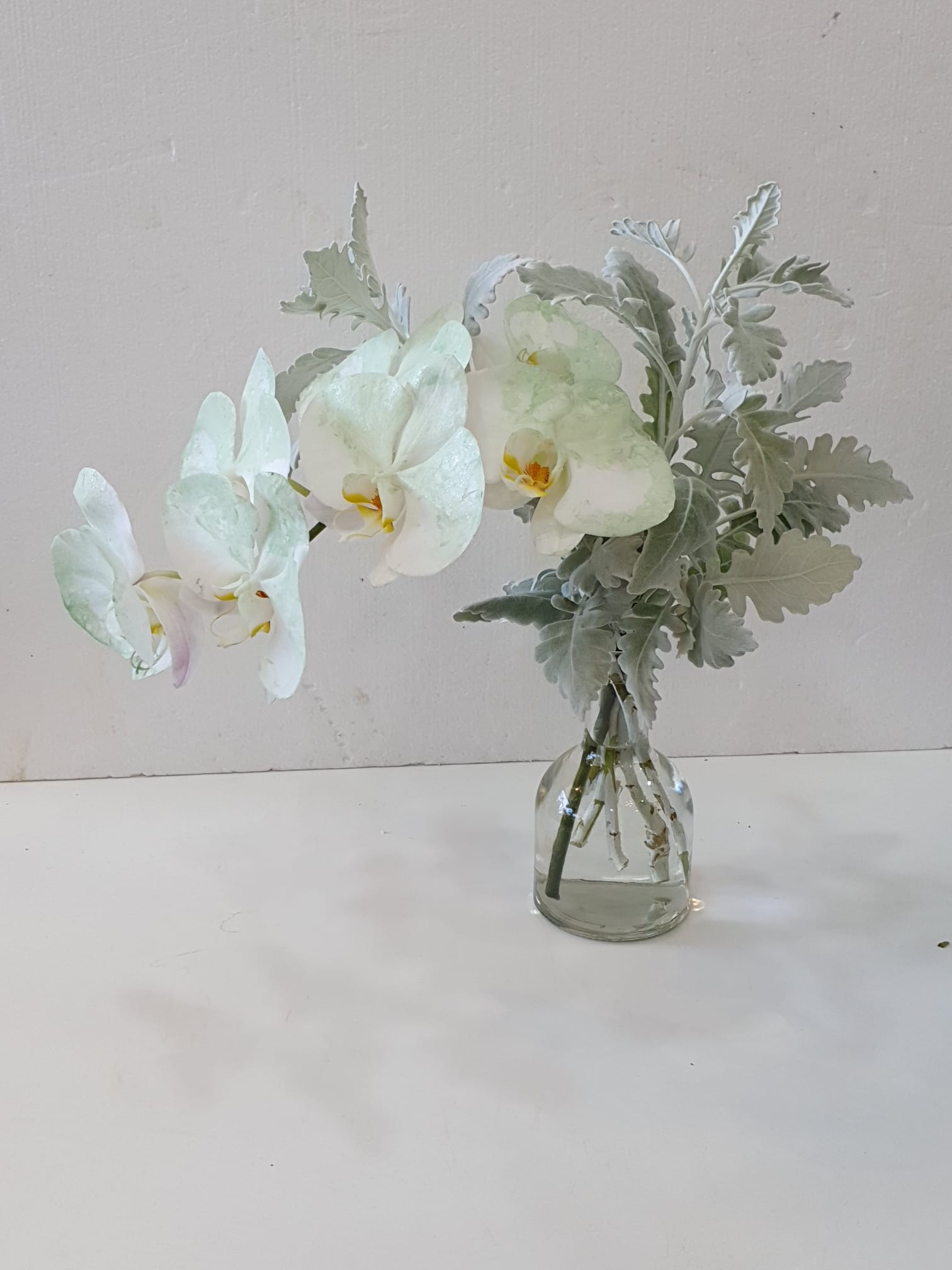 christening table arrangement - white orchids and greenery