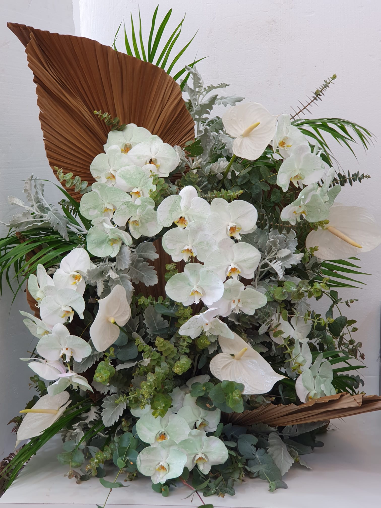 christening flowers in white and green foliage 