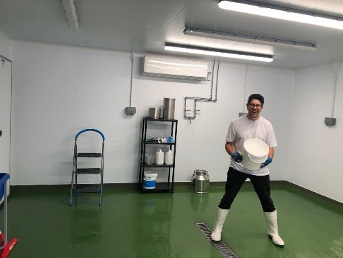 Martin Tkalez holds a bucket in his make room