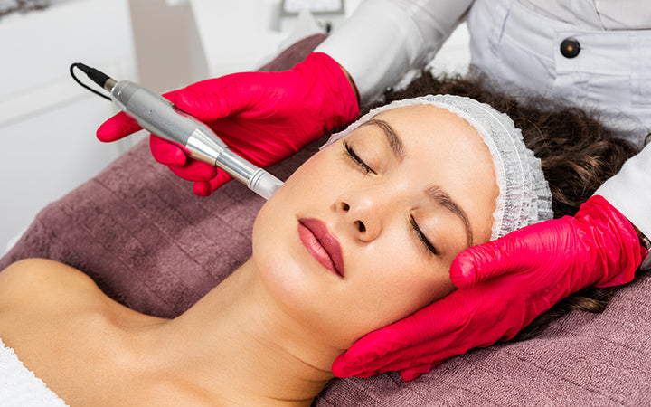 woman receiving microneedling rejuvenation treatment