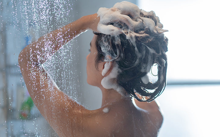 woman washing hair showering
