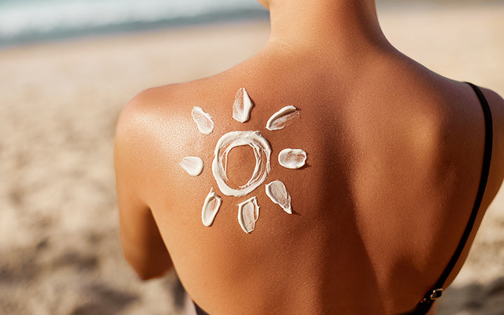 woman with sun cream on tanned shoulder