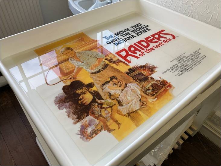 An original movie poster being washed prior to linen-backing