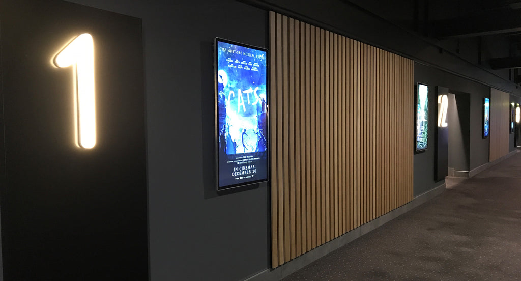 Backlit movie poster light boxes in a cinema