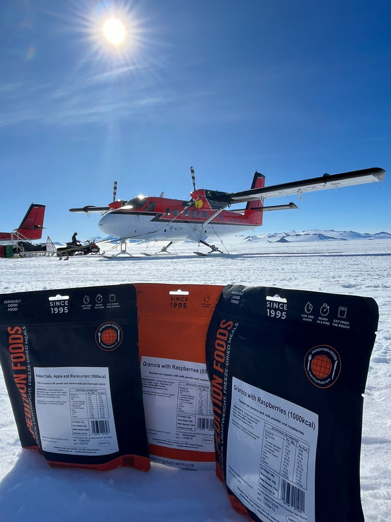 meal pouches in front of ALE's twin prop plane parked up.