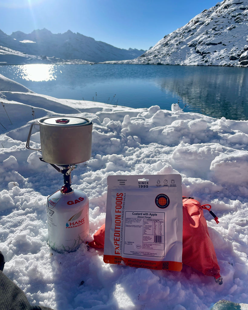 Expedition Foods meals being prepared next to a stove on a snow field