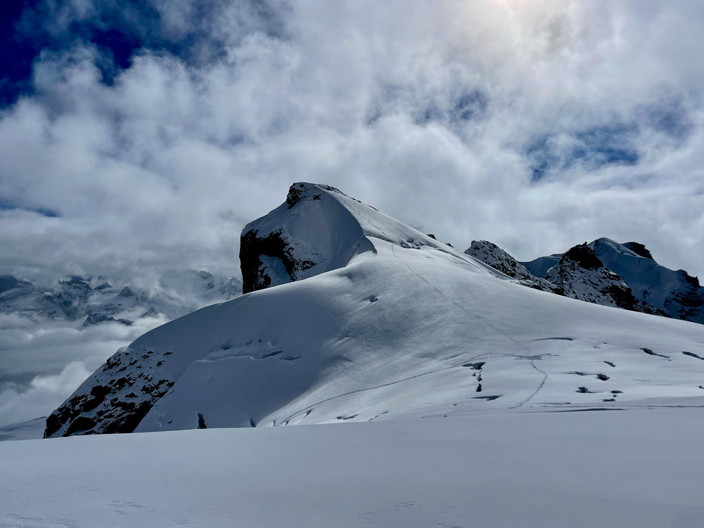 Snowy mountains and cloudy skies