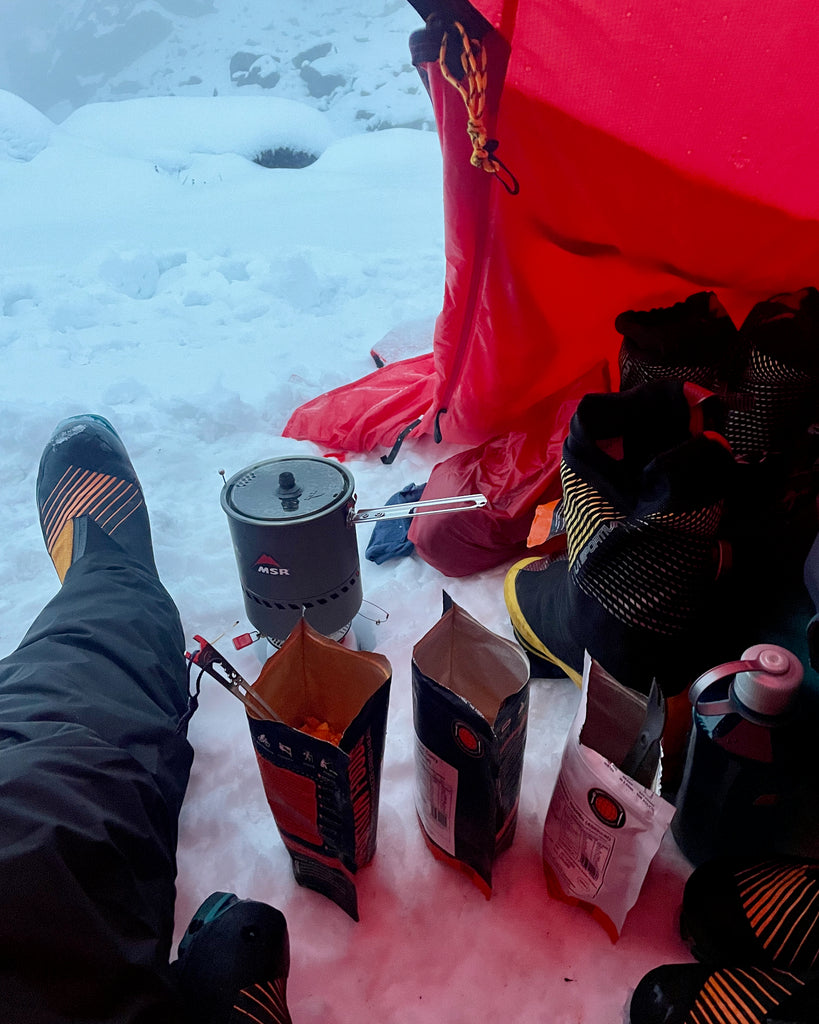 Expedition Foods being prepared in the vestibule of a tent.