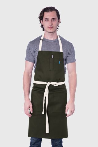 Image of person wearing Line apron in olive.
