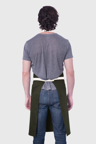 Back view image of person wearing olive apron.