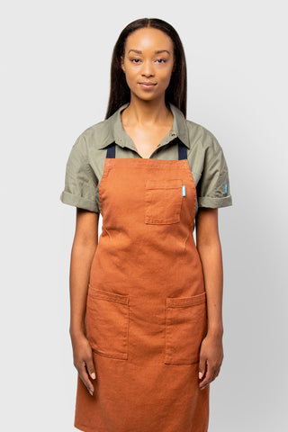 Image of person wearing Lucca Linen apron in crimson