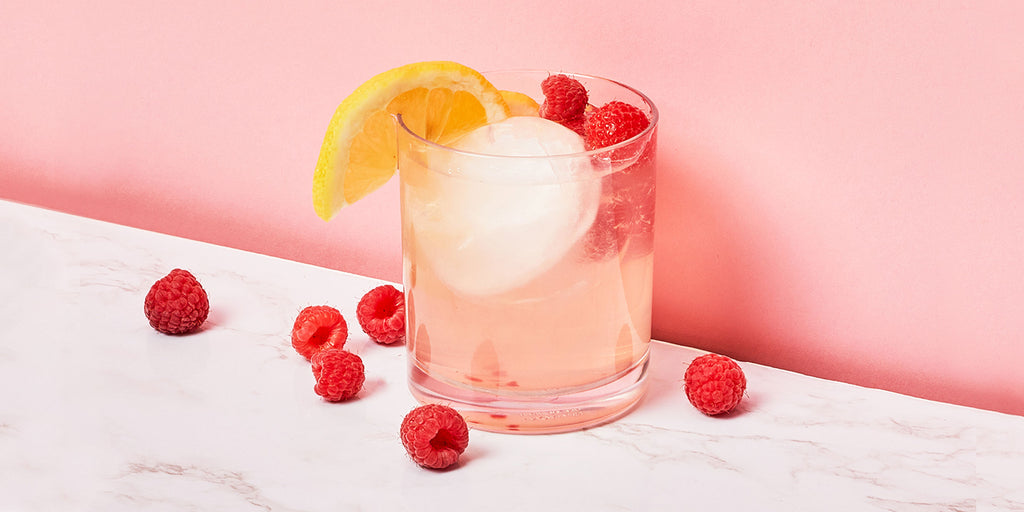 An image of ZOKU’s Raspberry Lemonade Cocktail against a pink background.
