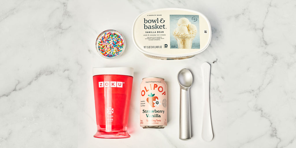 A flat lay image of the ingredients for how to make a slushy with soda. The ingredients include a can of quality soda with optional ice cream and sprinkles next to a ZOKU Slush & Shake Maker.