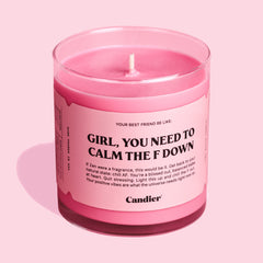 A cute pink candle with a label that reads girl you need to calm the f down