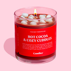 A cute hot chocolate colored candle that topped with wax marshmallows and a red label that reads hot cocoa and cozy cuddles