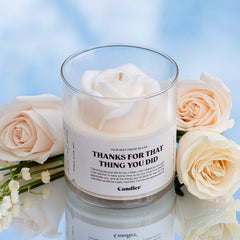 A cute white candle topped with a realistic wax rose and a label that reads thanks for that thing you did