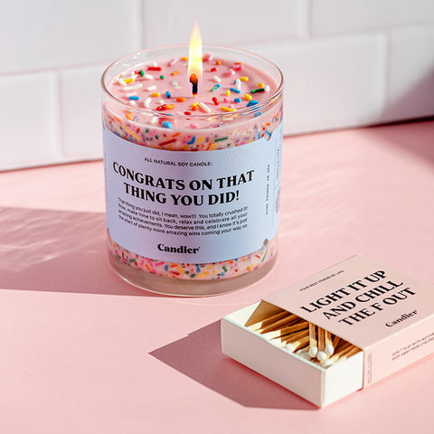 A colorful candle with sprinkles and a label that reads Congrats on that thing you did