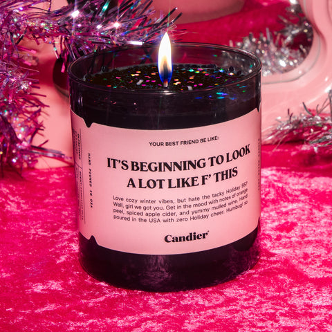 A fun grinchy Christmas themed candle with a label that reads It's Beginning To Look A Lot Like F This