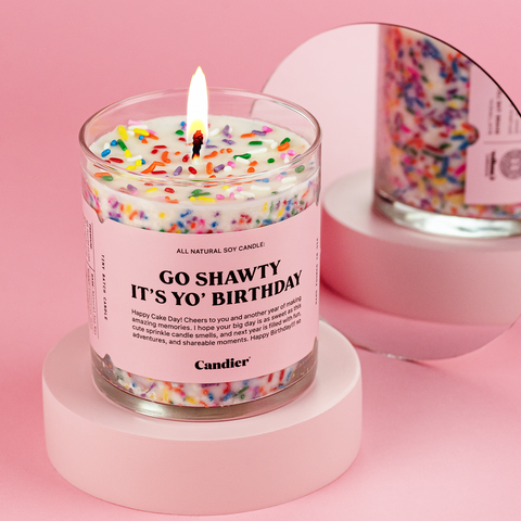 a colorful birthday cake candle with a label that reads Go shawty it's yo birthday