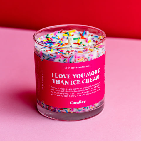 A candle with colorful sprinkles and a bright pink label that reads I Love You More Than Ice Cream