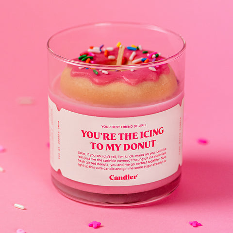 A love themed candle with a large wax frosted donut and a message that reads You're The Icing To My Donut