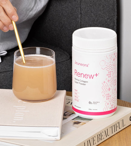 Renew+ Marine Collagen Powder beauty supplement and glass sitting on coffee table in morning routine