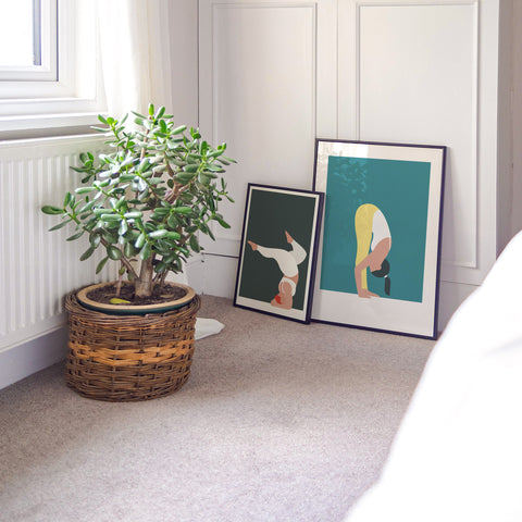 calm soothing bedroom with two yoga pose prints resting up against the wardrobe