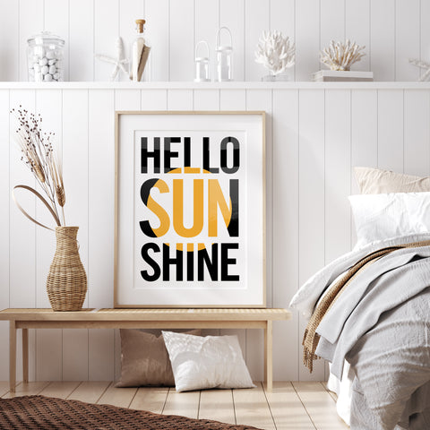 hello sunshine typography print sits on a wooden bench in a scandi style bedroom with a jute rug and seagrass basket with pampass