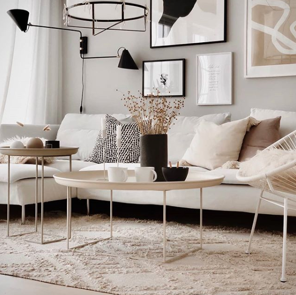 Pared back simple living room decor with neutral walls and sofa, lots of texture and dark accents