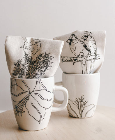 black and white floral mugs and bird printed tea towels 