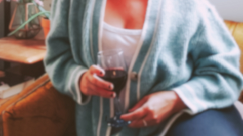 cozy on the couch in soft sweater with wine