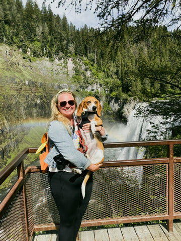 Girl and beagle by a waterfall with bandanas on 
