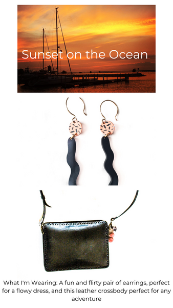 Picture of sunset with sail boats, pink and black long wavy earrings, black leather crossbody bag with pink purse charm