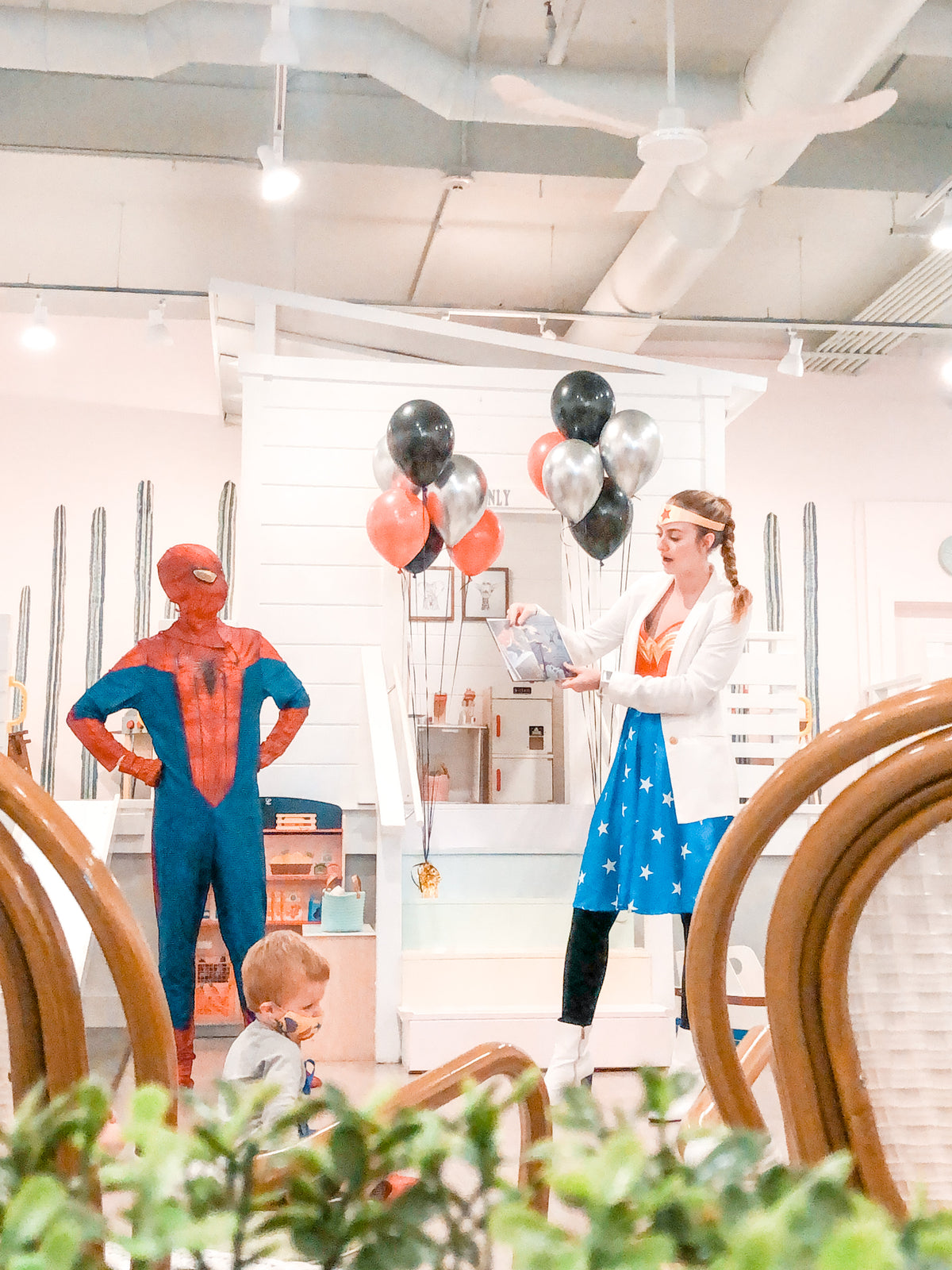 Wonder Woman and Spiderman reading stories to children at Waterlemon Kids. 